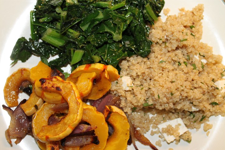 Delicata squash served with kale and quinoa
